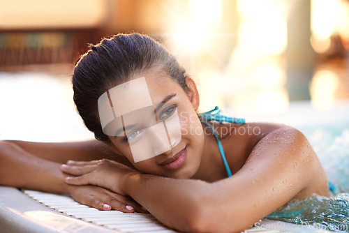 Image of Happy woman, relax and jacuzzi with warm water for holiday, getaway or stress relief at hotel, resort or spa. Face of calm and young female person with smile in hot tub, pool or treatment on vacation