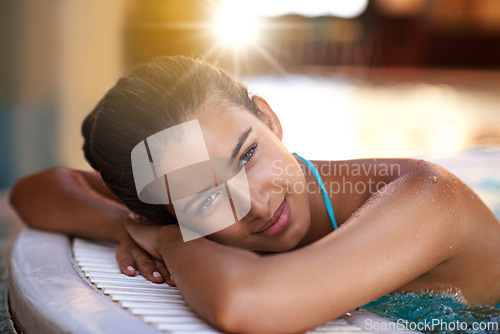 Image of Happy woman, relax and water with jacuzzi at spa for holiday, getaway or stress relief at hotel or resort. Face of calm and young female person with smile for hot tub, warm pool or peace on vacation