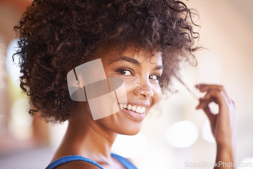 Image of Woman, portrait and happiness in hair care with bokeh, natural beauty and collagen treatment with confidence. African person, face and smile with afro hairstyle, wellness or lens flare in Amsterdam