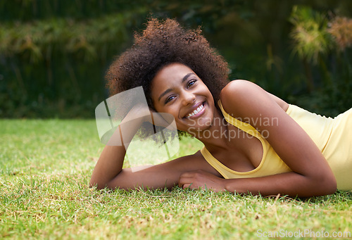 Image of Happy, grass and portrait of black woman in garden for relaxing, calm and peace in park. Smile, nature and person laying outdoors for holiday, vacation and weekend for wellness, fresh air and joy