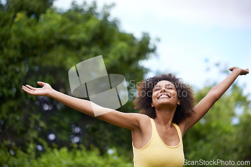 Image of Happy, open arms and black woman in park for freedom, adventure and relax in nature. Smile, excited and person with happiness, positive attitude and fun outdoors for holiday, vacation and weekend