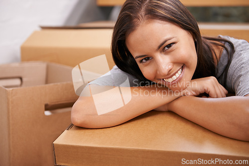 Image of Woman, portrait and boxes in home, smile and proud of real estate investment and relocation. Female person, happy and mortgage for new property and cardboard for moving house, homeowner and purchase