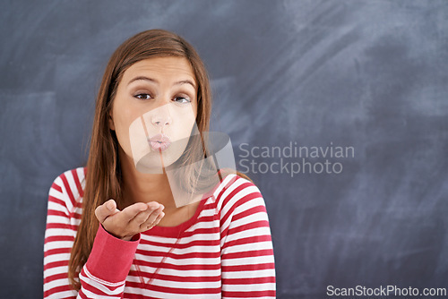 Image of Portrait, woman and blowing a kiss with blackboard, romance and funny with fun and mockup space. Face, person and girl with love and symbol with emoji and icon with model and cheerful with happiness