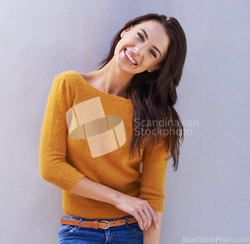 Image of Woman, smile and mockup with fashion, portrait and proud with sweater for comfort. Model, happy and positive for natural, fun and confidence for trendy style or cool isolated on grey wall background