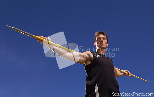 Image of Man, athlete and javelin or blue sky at sport competition on grass or workout fitness or outdoor, strength or training. Male person, challenge and target strong or exercise performance, aim or skill