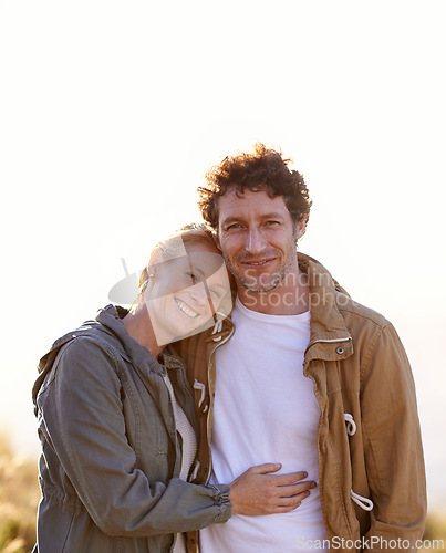 Image of Happy couple, hug outdoor and portrait in park, love and support with date for bonding and time together. Sunset, nature and people in forest for fresh air, loyalty and commitment with smile