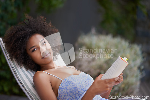 Image of African, woman and book at resort for relax, peace and chill on vacation. Happy, natural portrait of black female person reading in nature, retreat and on holiday for confidence in summer in dress