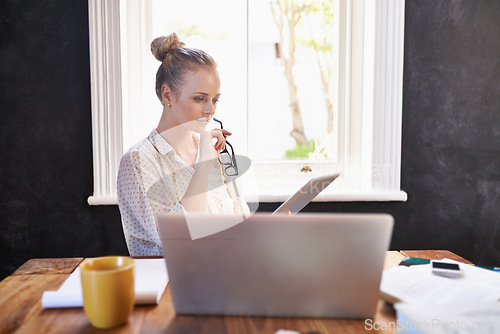 Image of Home, office and woman with tablet reading a review online with professional research or news in business. Search, internet and learning from information on tech or knowledge from website or ebook