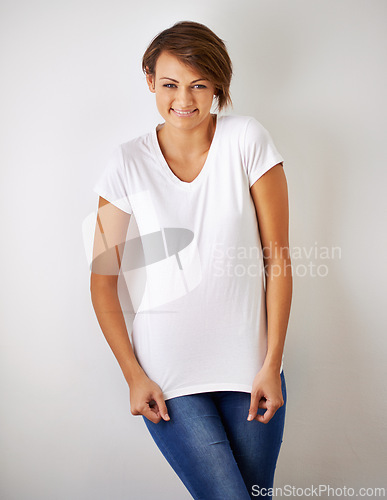 Image of Portrait, fashion and smile with young woman in studio on white background for casual or relaxed style. Model, happy and clothes with confident person in trendy clothing outfit for natural chic