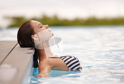 Image of Summer, peace and woman relax in swimming pool on luxury holiday or vacation at hotel or villa in Cancun. Person, outdoor or enjoy calm water at resort in Mexico or girl in bikini or swimsuit fashion