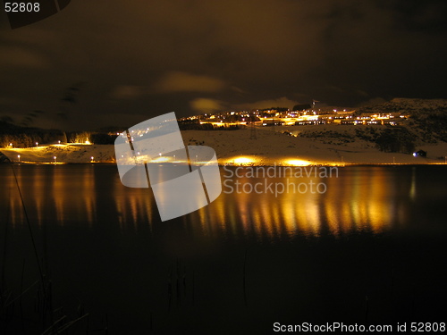 Image of Lights reflecting in water at night