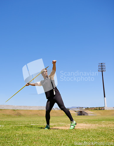 Image of Man, athlete and javelin throw or sport competition on grass for workout fitness or outdoor, strength or training. Male person, challenge and target strong or exercise performance, aim or wellness