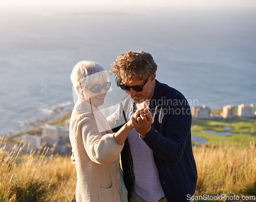 Image of Happy, holiday and couple outdoor in dance on hill or mountain in Cape Town and holding hands with love. Mature, people and embrace with kindness on vacation adventure in nature and relax together
