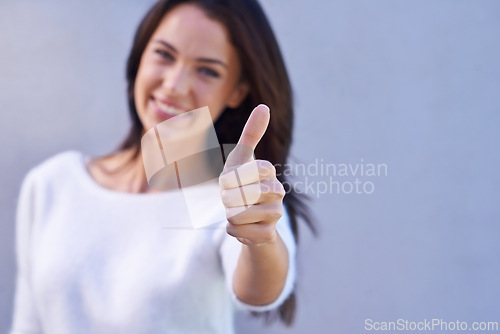 Image of Thumbs up, happy and portrait of woman with success, winner and goal reached isolated on gray background. Hand, female person and gesture for yes, thank you and achievement with smile in studio