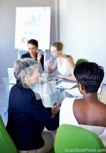 Image of Meeting, office and business women in discussion, talking and collaboration with statistics. Teamwork, corporate and women with chart, graph and research presentation for planning, review and growth