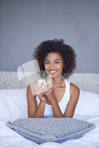 Image of Black woman, portrait and relax with coffee in bed for morning, breakfast or hot beverage at home. Face of happy African female person with smile or afro for latte or cappuccino in bedroom at house