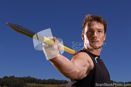 Image of Portrait, javelin and man with fitness, training and blue sky with sports and wellness with practice. Face, person and athlete with tournament and competition with exercise and workout with blue sky