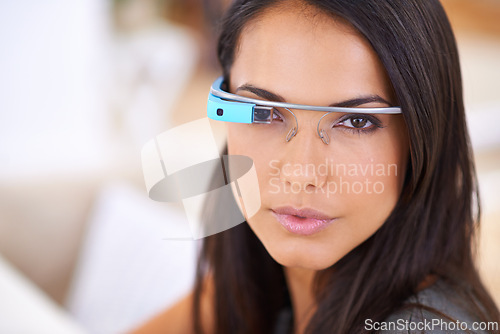 Image of Woman, portrait and serious with smart glasses in home for virtual reality, high tech information and digital eyewear. VR, person and futuristic vision for communication, research and mockup in house