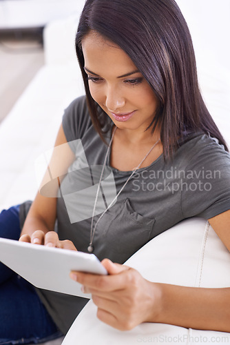 Image of Woman, couch and tablet for browse on app in home, comfortable and website for entertainment. Female person, online and internet for blog and subscription, living room and relax on sofa for series