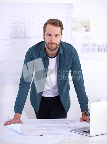 Image of Portrait, laptop and blueprint with architect man in office with documents for building, design or planning. Architecture, construction and industry with confident young developer in workplace