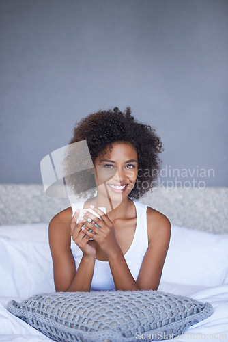 Image of Black woman, portrait and relax with coffee in bedroom for morning, breakfast or hot beverage at home. Face of happy African female person with smile or afro for latte or cappuccino in bed at house