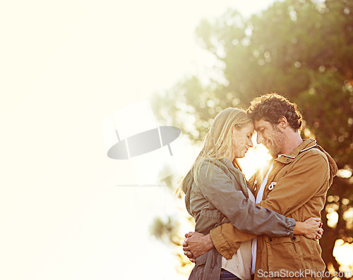Image of Couple, hug outdoor and sunset in forest, love and peace with trust for commitment in marriage. Partner, nature and people with forehead touch, natural light and mockup space with embrace and support