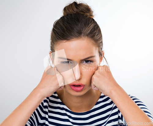 Image of Portrait, frustrated and angry with woman, stress and anxiety on a white studio background. Face, person and model with reaction and extreme emotion with expression and upset with emoji and crisis