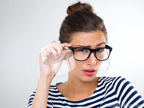 Image of Confused, woman and portrait with surprise in studio, white background and mockup of questions. Doubt, why and college student with glasses thinking of feedback or information with anxiety or stress