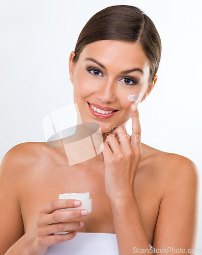 Image of Woman, portrait and cream for skincare with beauty in studio, cosmetics product in container and makeup on white background. Sunscreen, lotion or moisturizer for facial, antiaging and skin treatment