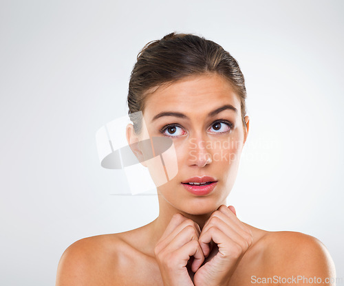 Image of Woman, thinking and nervous about skincare, beauty and cosmetics in a studio on white background. Inspiration for antiaging, solution to dry skin and glow with waiting for results from treatment