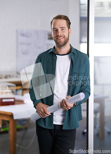 Image of Portrait, smile and blueprint with architect man in office with documents for building, design or planning. Architecture, construction and industry with happy young developer in creative workplace