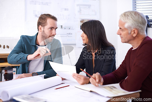 Image of Architecture, planning and teamwork in meeting with paperwork, discussion and blueprint for building project. Civil engineering, development and business people, men and woman in office brainstorming