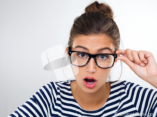 Image of Confused, woman and portrait with surprise in studio, white background and mockup with questions. Doubt, why and student with glasses and emoji of anxiety for feedback or information with stress