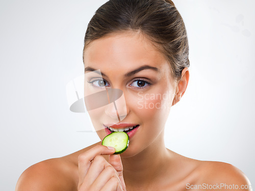 Image of Woman, portrait or cucumber for eating in studio with wellness detox, healthy vegetable or nutrition diet. Model, person or fruit for organic cosmetics, natural beauty or skincare on white background