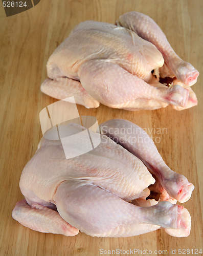 Image of Two raw chickens on a chopping board
