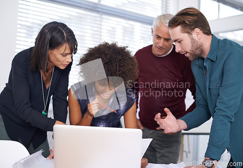 Image of Web designers, laptop and plans with office, diversity and meeting or creative partnership. Employees, discussion and collaboration for blueprint, brainstorming and problem solving for startup agency