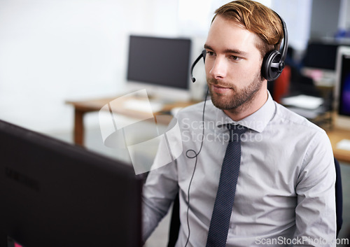 Image of Call center, customer support and man in office with headset working on online telemarketing consultation. Career, ecommerce and male consultant or agent with crm service communication in workplace.