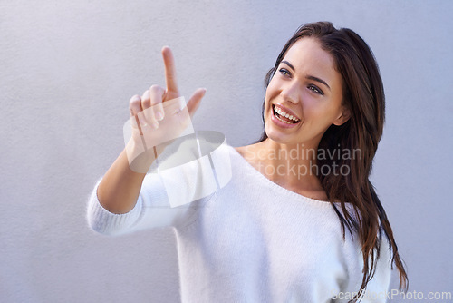 Image of Fashion, pointing and woman with smile for sweater with warm, texture and casual for winter. Studio background, female person with happiness, joy and girl with jersey of wool for comfort in New York