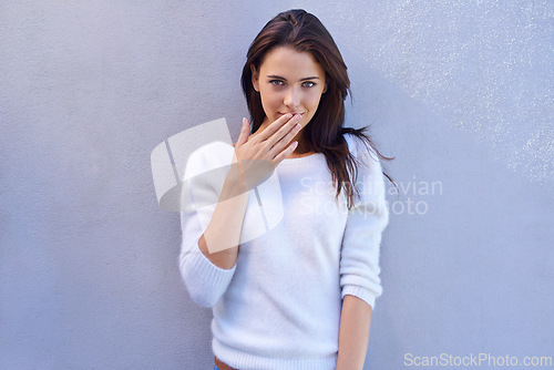 Image of Portrait, woman and hand on mouth in studio for fashion, trendy or cool style while standing on white background. Female person, sweater or jumper with reaction stylish or edgy in casual outfit