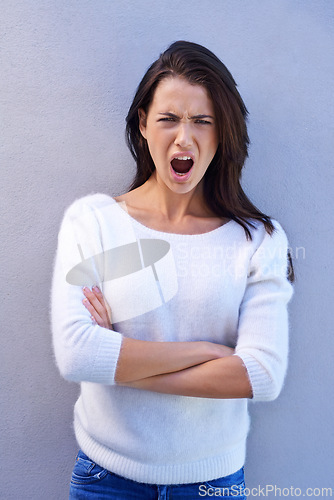 Image of Studio, portrait and woman feeling offended, shocked and angry with emotion and confused by news. Blue background, female person and girl with question of why with arms crossed and surprised