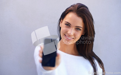 Image of Portrait, woman and smartphone with screen in studio for connectivity, communication and mobile with technology. Female person, cellphone and chatting or texting in gray background for conversation