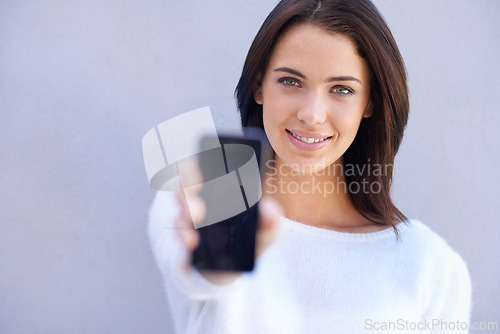 Image of Portrait, smile and woman with phone, presentation and product placement for advertising mobile. Studio background, female person and girl with happiness for cellphone, digital and technology