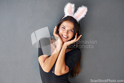 Image of Bunny ears, happy or portrait of woman with fashion isolated on wall or grey background with style. Funny joke, confident lady or casual female person in studio with pride, smile and trendy clothes