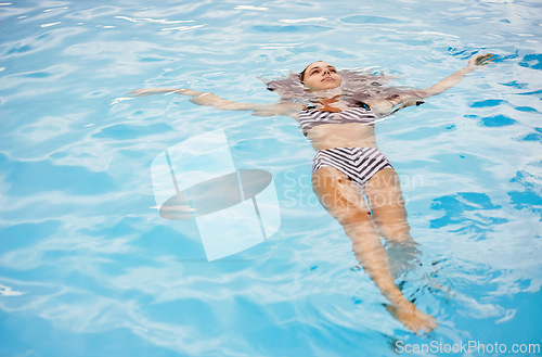 Image of Bikini, swimming and woman in pool on holiday, vacation and travel to relax, calm and cool in summer. Female person, gen z girl and young lady floating with water, mockup space and outdoor in Spain