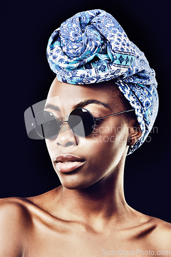 Image of Face, fashion and culture with African model in studio isolated on black background for heritage. Aesthetic, woman and sunglasses with confident young person in trendy headwear for traditional style