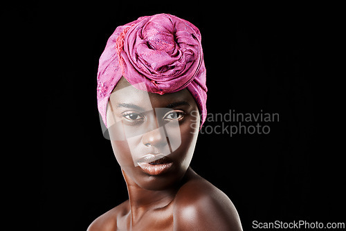 Image of Black woman, head scarf and beauty portrait with serious, skincare and natural cosmetics in studio. Traditional, turban and African fashion with wellness and skin glow with makeup and dark background