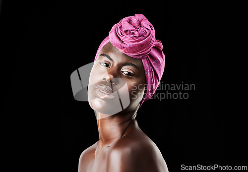 Image of Black woman, head wrap and portrait with natural beauty, skincare and cosmetics in studio. Traditional, turban and African fashion with wellness and skin glow treatment in makeup with dark background