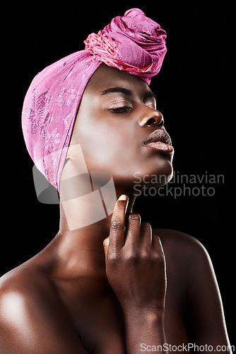 Image of Black woman, head wrap and beauty with profile, skincare and natural cosmetics in studio. Traditional, turban and African fashion with wellness and skin glow treatment with makeup and dark background