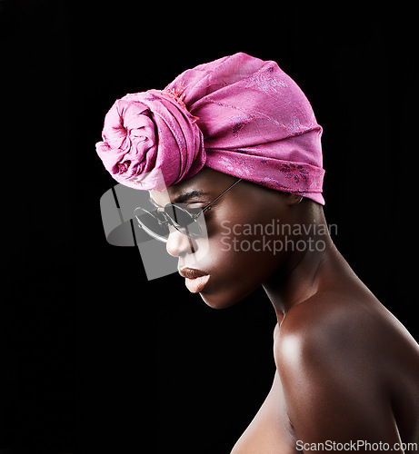 Image of Profile, fashion and culture with African woman in studio isolated on black background for heritage. Aesthetic, face and sunglasses with confident young model in trendy headwear for traditional style