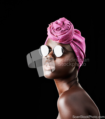 Image of Face, fashion and shades with African woman in studio isolated on black background for heritage. Beauty, model and sunglasses with confident young person in trendy headwear for traditional style